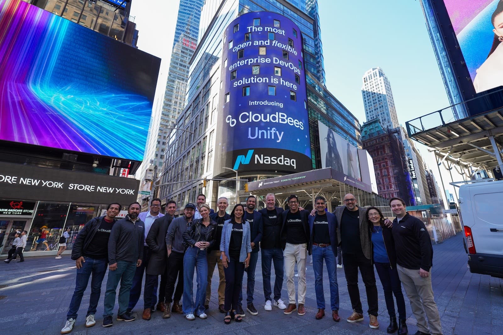 The CloudBees team in Times Square in front of the Nasdaq tower, which reads: The most open and flexible enterprise DevOps solution is here. Introducing CloudBees Unify.